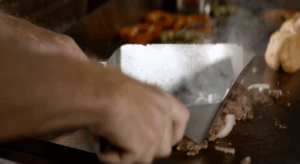 chopping steak on grill